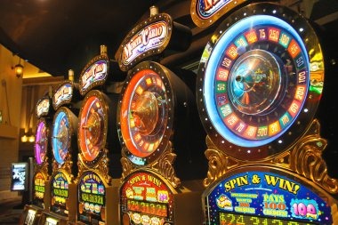 Multi-table casino floor view showing roulette and baccarat stations